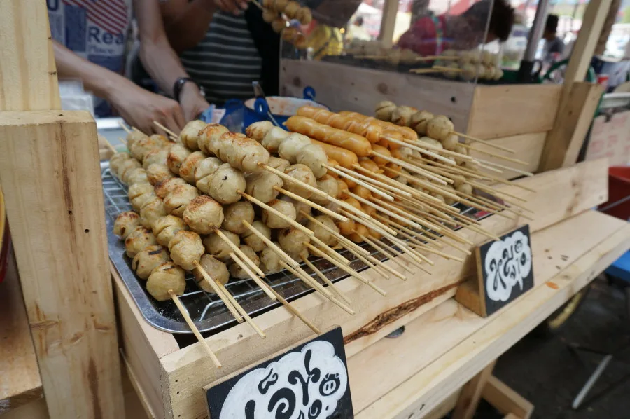 look chin (beef, chicken and pork balls on a stick) at Chatuchak market JJ market Bangkok Thailand street vendor