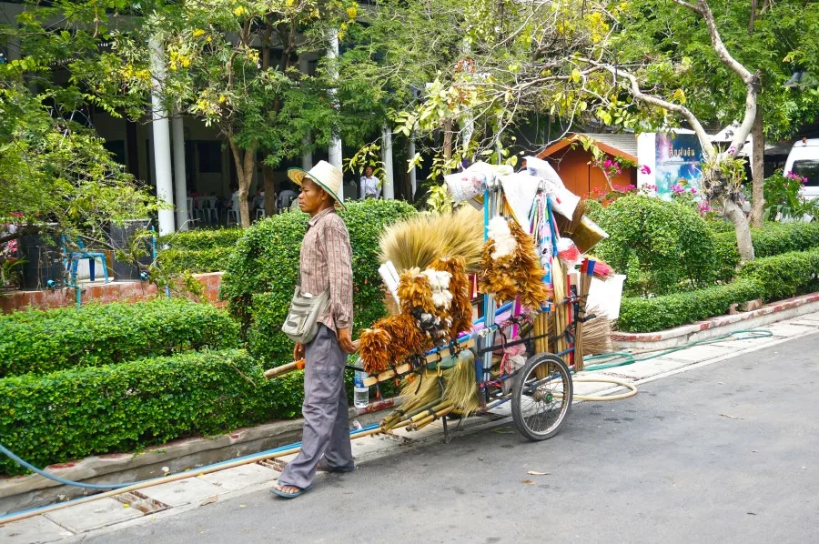 thai broom vendor street cart